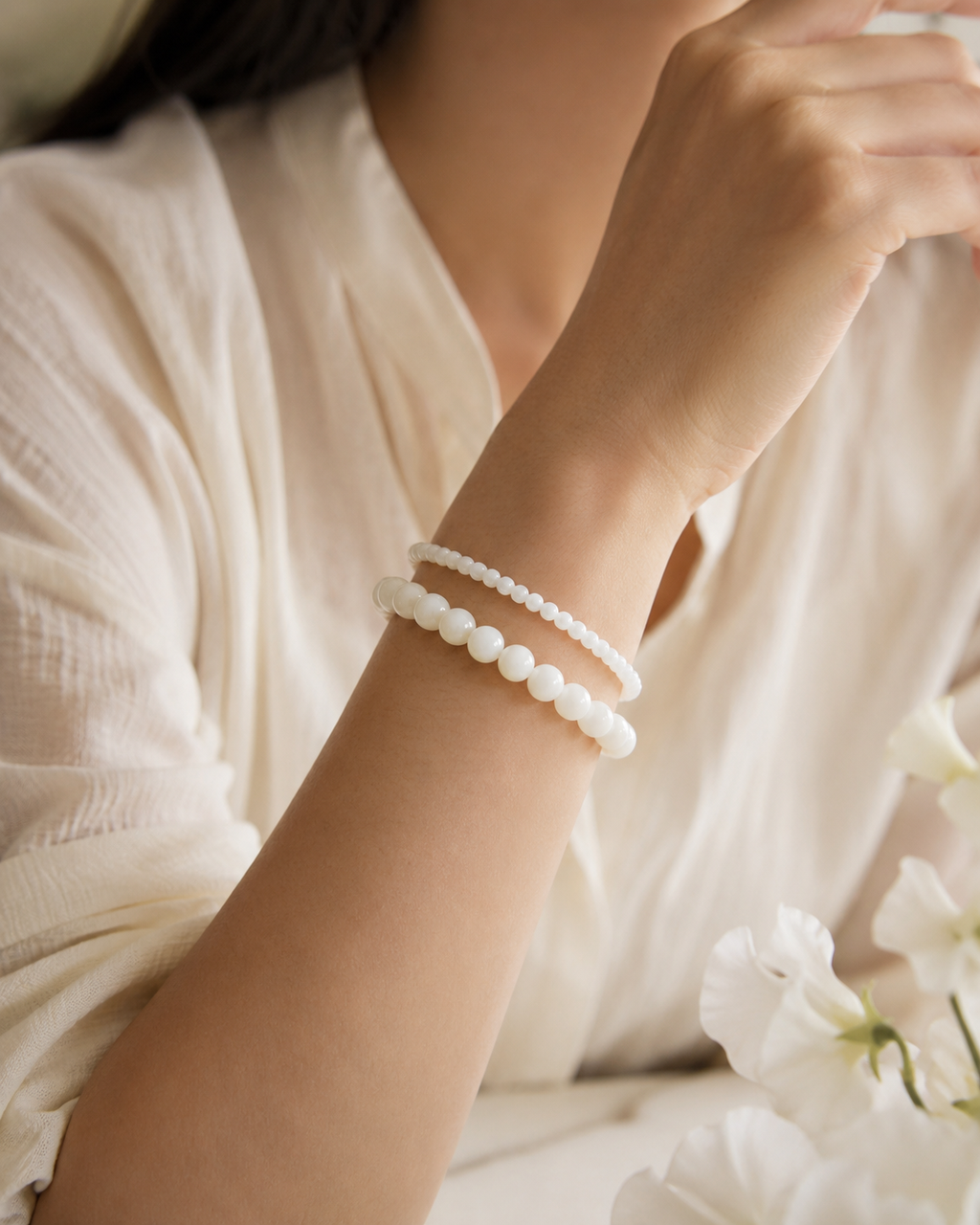 Detail view of Soft Tide White Shell Bracelet by AURAM with white shell beads for coastal layering