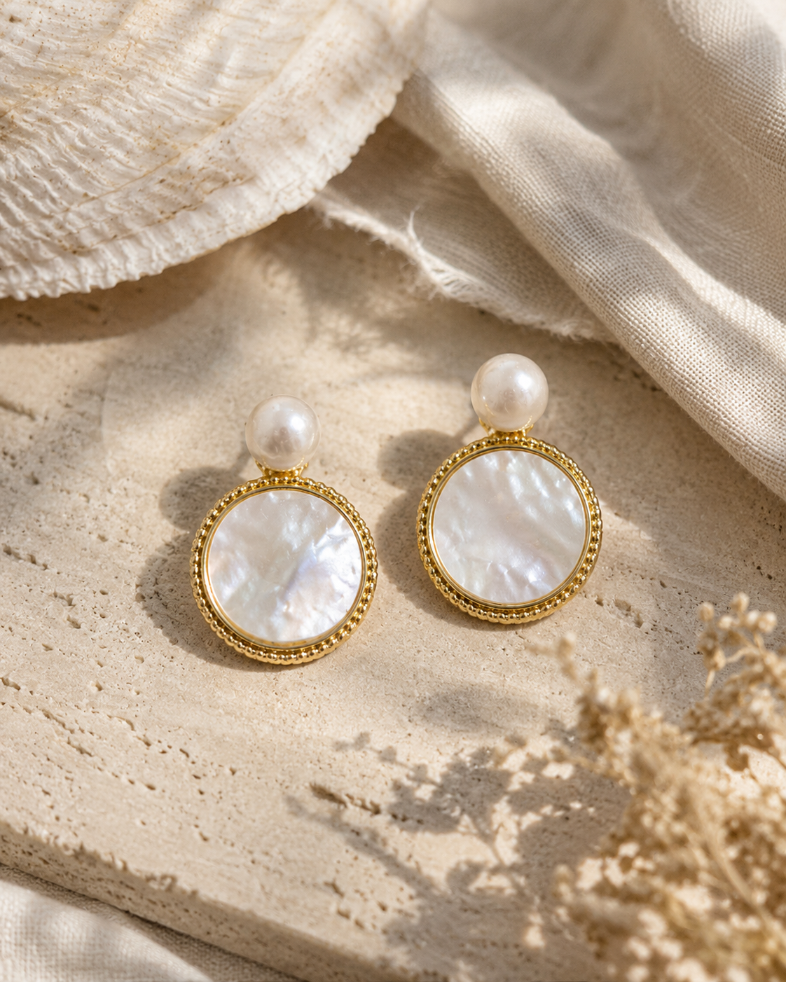 Detail view of Moonlit Shell Pearl Earrings by AURAM with shell-inspired pearl styling