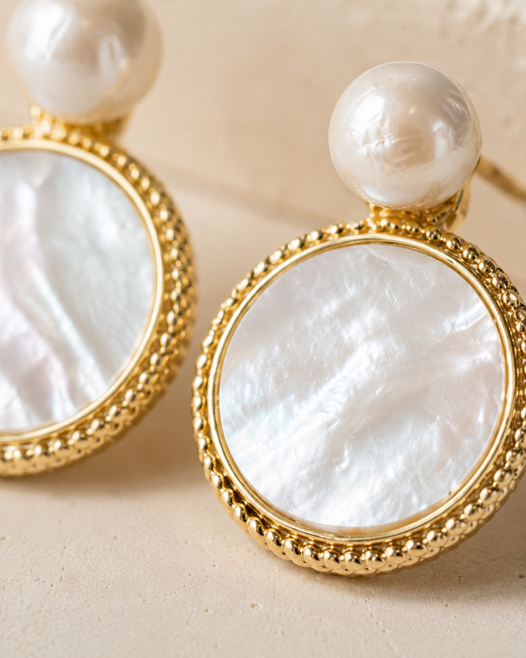 Styled view of Moonlit Shell Pearl Earrings by AURAM with shell-inspired pearl styling