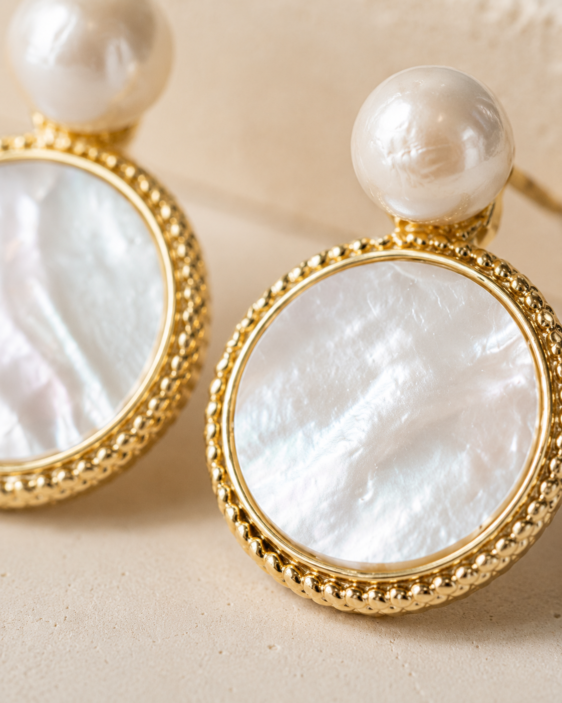 Styled view of Moonlit Shell Pearl Earrings by AURAM with shell-inspired pearl styling