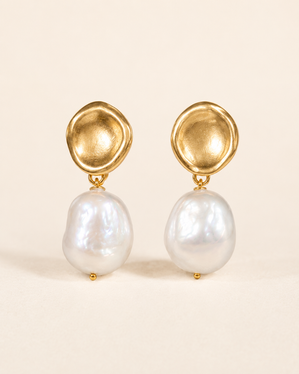 Styled view of Golden Halo Baroque Pearl Drop Earrings by AURAM with gold-tone halo detail