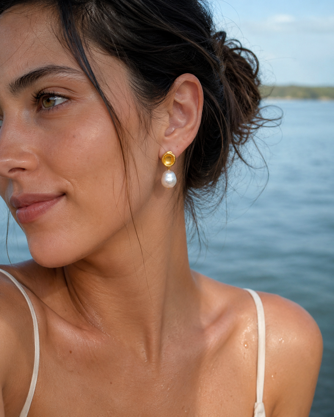 Detail view of Golden Halo Baroque Pearl Drop Earrings by AURAM with gold-tone halo detail
