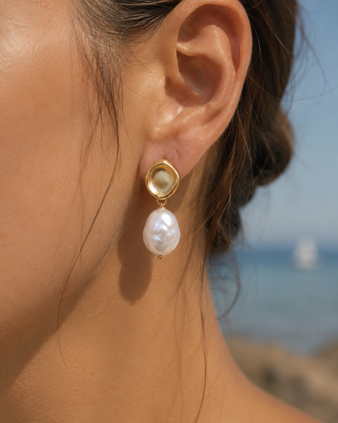 Detail view of Golden Halo Baroque Pearl Drop Earrings by AURAM with gold-tone halo detail