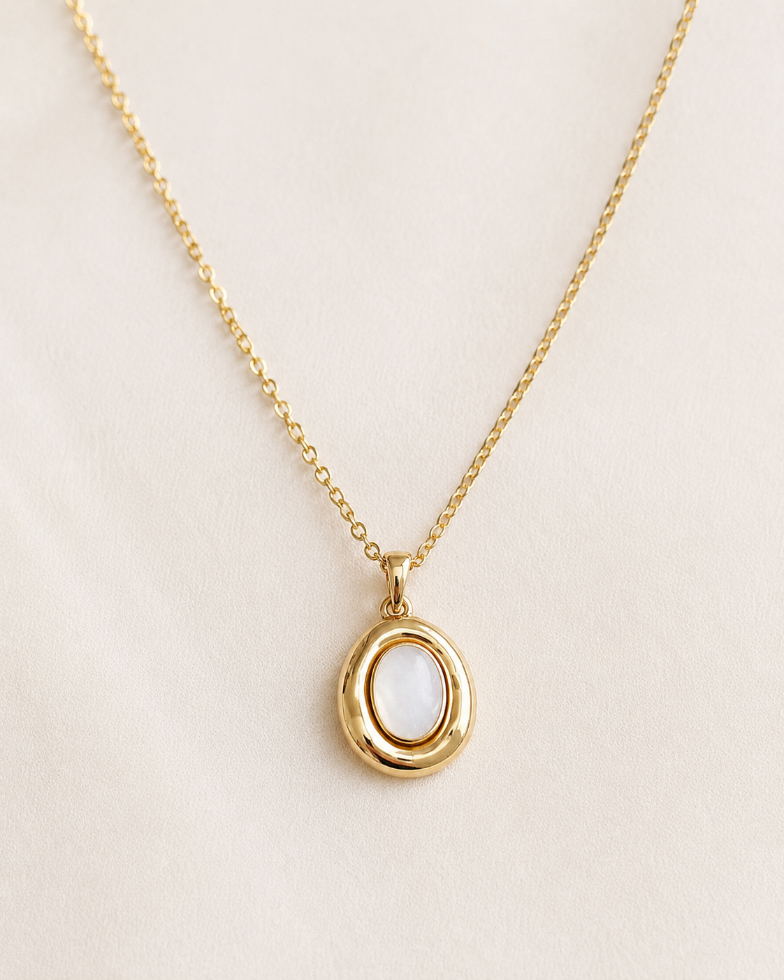 Styled view of Moon Cove Mother-of-Pearl Pendant Necklace by AURAM with moon-inspired shell pendant