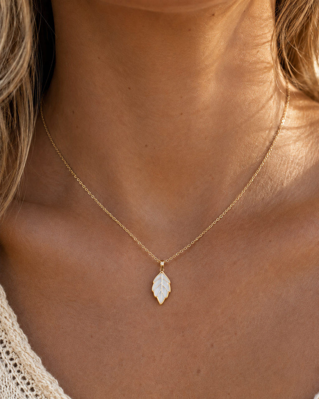Detail view of Leaf Glow Mother-of-Pearl Pendant Necklace by AURAM with leaf-inspired shell pendant
