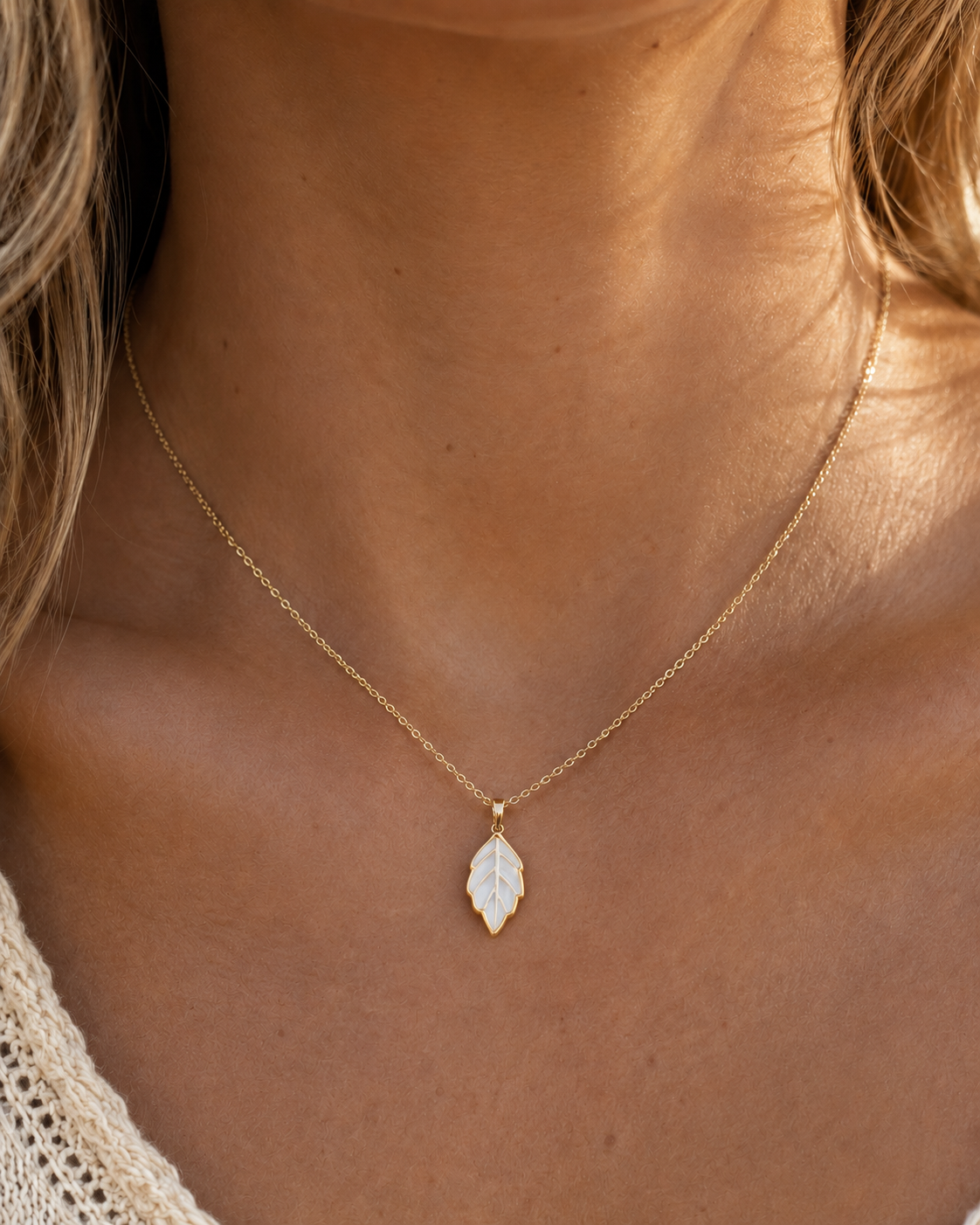 Detail view of Leaf Glow Mother-of-Pearl Pendant Necklace by AURAM with leaf-inspired shell pendant