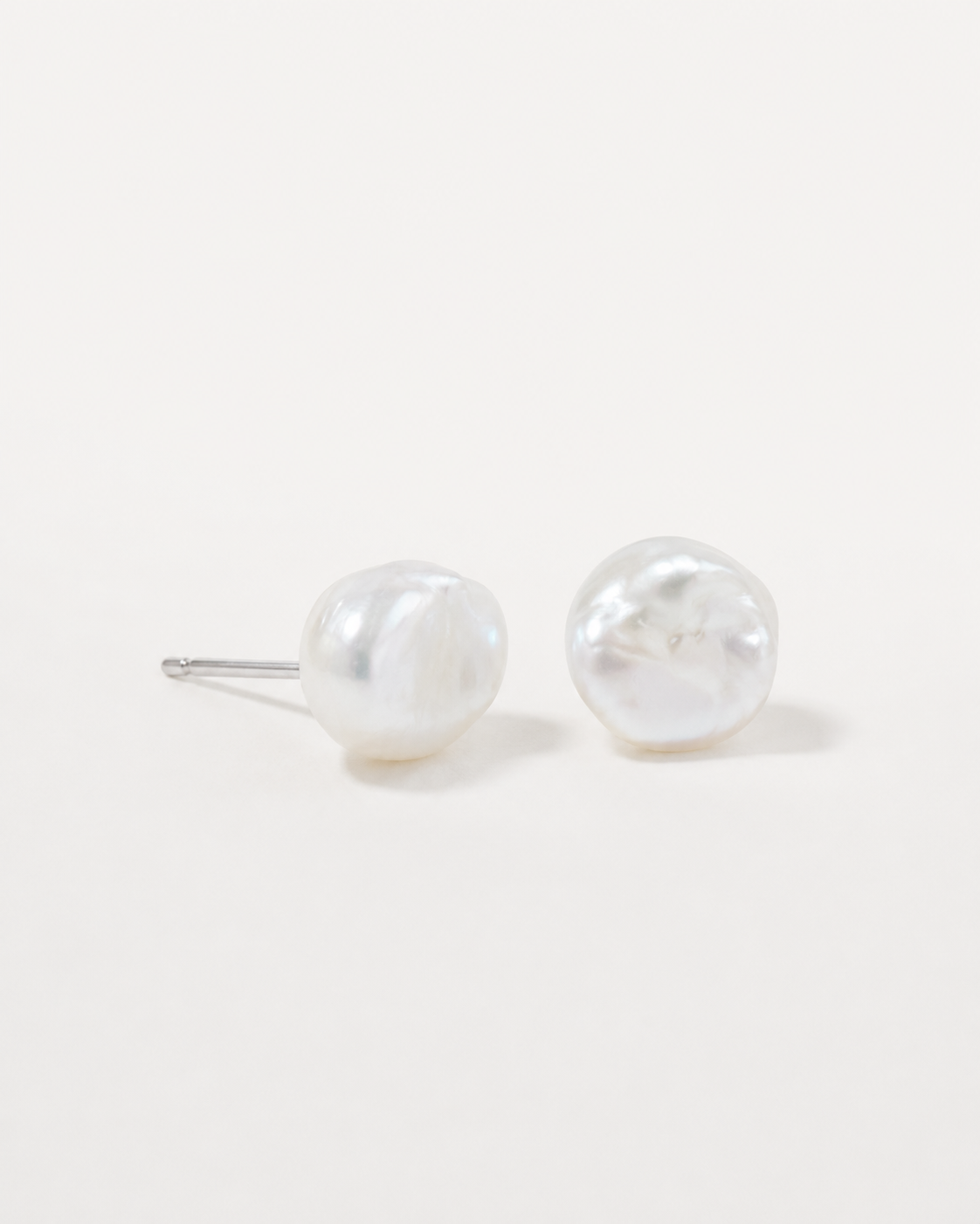 Detail view of Tiny Pearl Studs by AURAM, minimal everyday pearl stud earrings