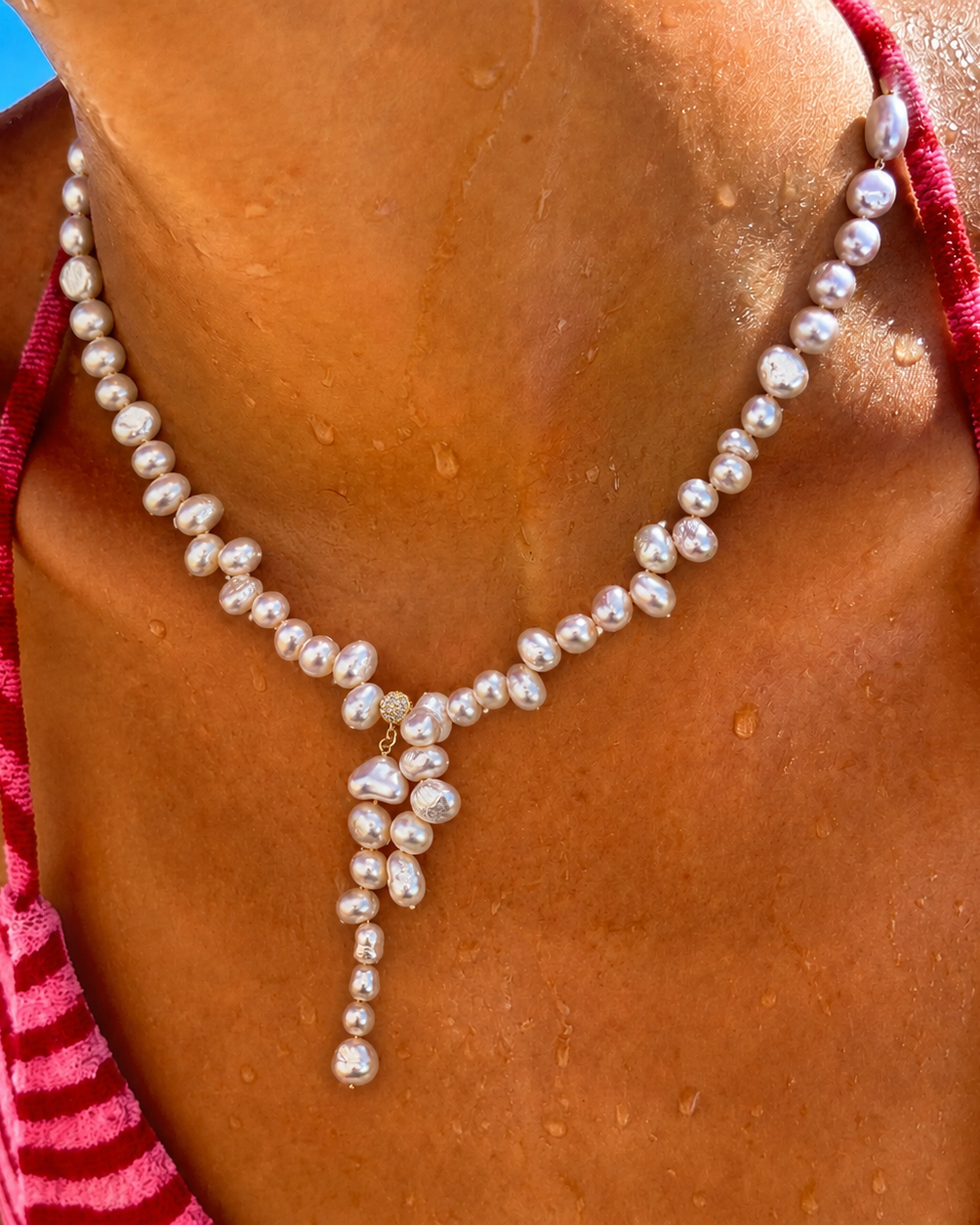 Detail view of Quiet Glow Baroque Pearl Necklace by AURAM with delicate Y-necklace styling