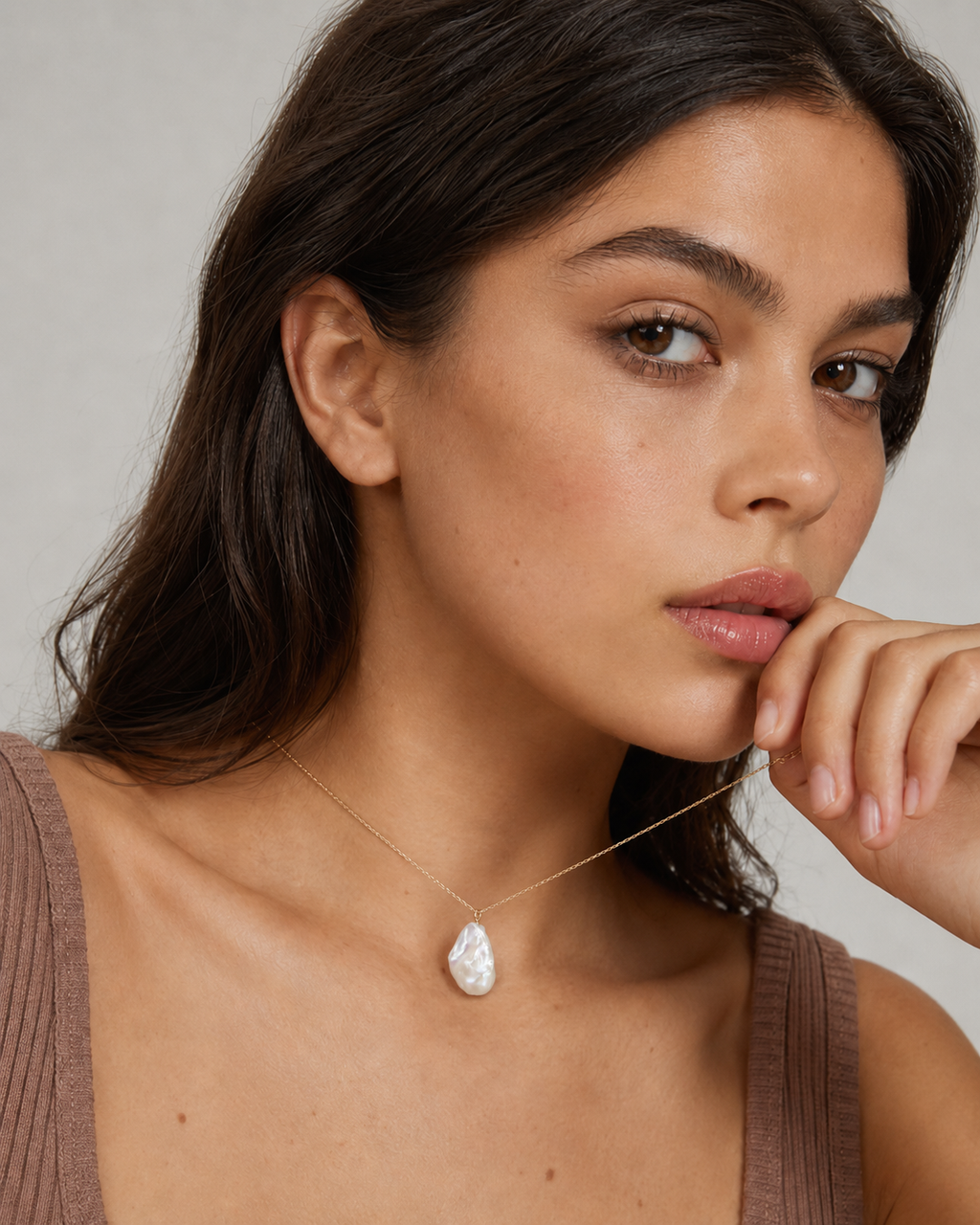 Close-up of baroque pearl pendant necklace showing organic pearl shape and soft luster